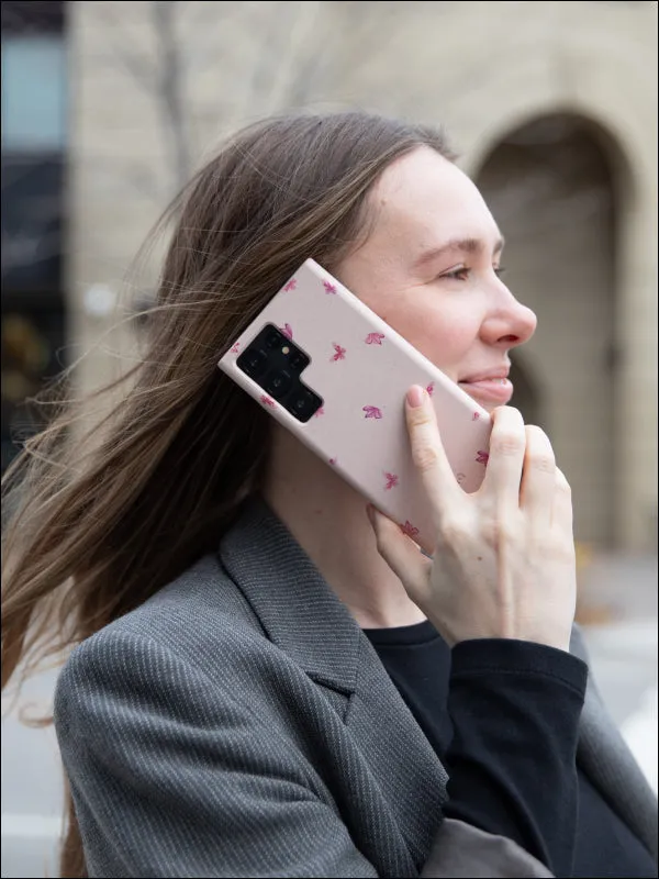 A woman on a phone call holding a Pela case against her ear